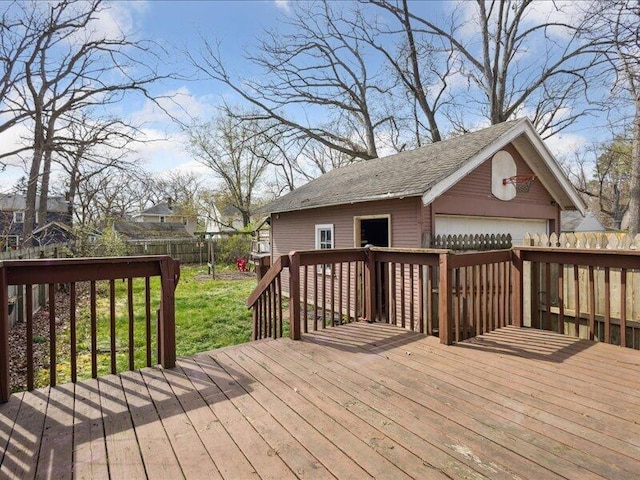 wooden deck with a garage, fence, and an outdoor structure