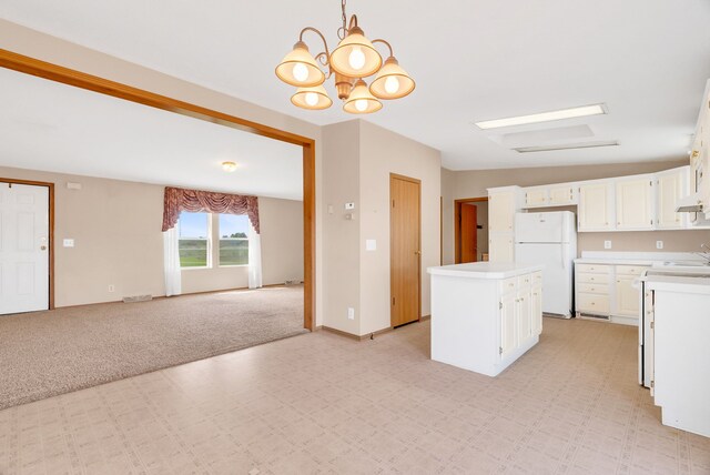 2326 Burnsline Rd, Brown City, MI 48416 - kitchen featuring freestanding refrigerator, a sink, light countertops, a chandelier, and open floor plan