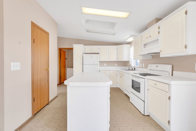 2326 Burnsline Rd, Brown City, MI 48416 - kitchen with white appliances, light floors, vaulted ceiling, a kitchen island, and light countertops