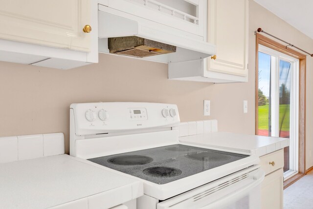 2326 Burnsline Rd, Brown City, MI 48416 - kitchen featuring electric stove, light countertops, under cabinet range hood, and white cabinetry