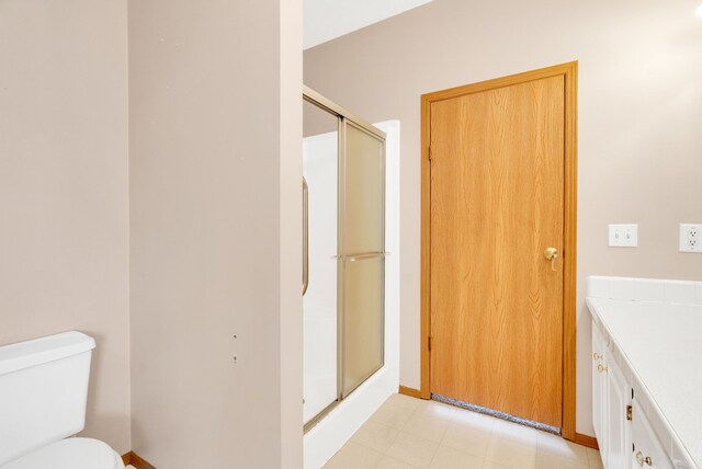 2326 Burnsline Rd, Brown City, MI 48416 - bathroom featuring a stall shower, toilet, vanity, and baseboards