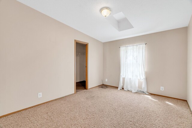 2326 Burnsline Rd, Brown City, MI 48416 - carpeted empty room with a skylight and baseboards