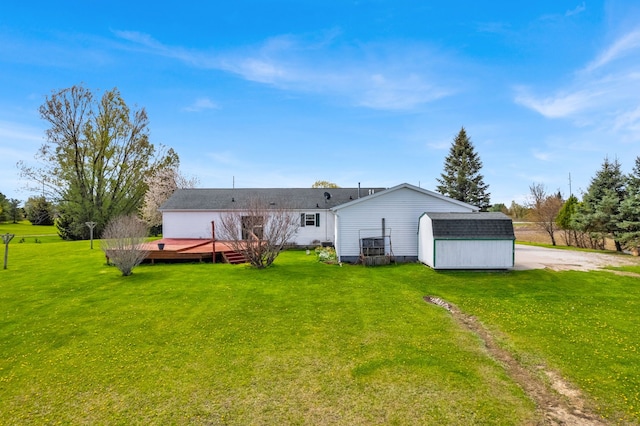 2326 Burnsline Rd, Brown City, MI 48416 - back of property featuring a storage shed, a deck, an outdoor structure, and a yard