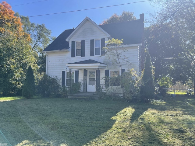 traditional-style house featuring fence, a chimney, and a front lawn