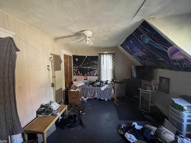 bonus room with concrete flooring, a textured ceiling, and ceiling fan