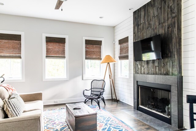 living area with plenty of natural light, wood finished floors, and a large fireplace