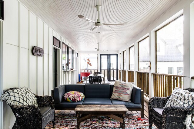 sunroom / solarium with ceiling fan and outdoor lounge area