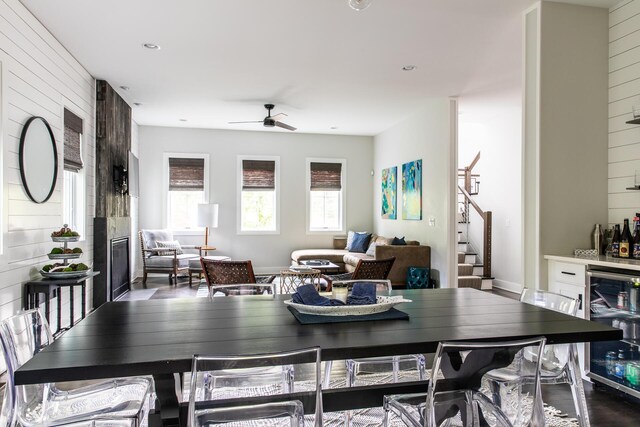 dining area with ceiling fan, a dry bar, stairway, wine cooler, and recessed lighting