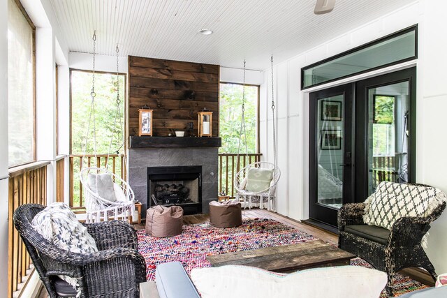 living room with a large fireplace and wood finished floors