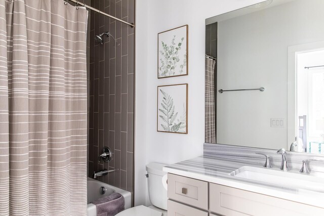 bathroom with vanity, shower / tub combo with curtain, and toilet