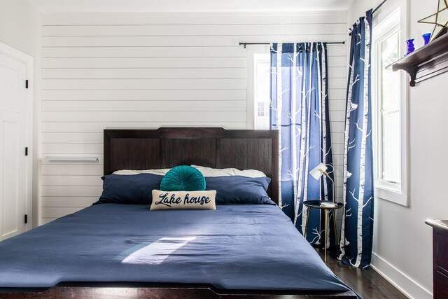 bedroom with baseboards and dark wood-style floors