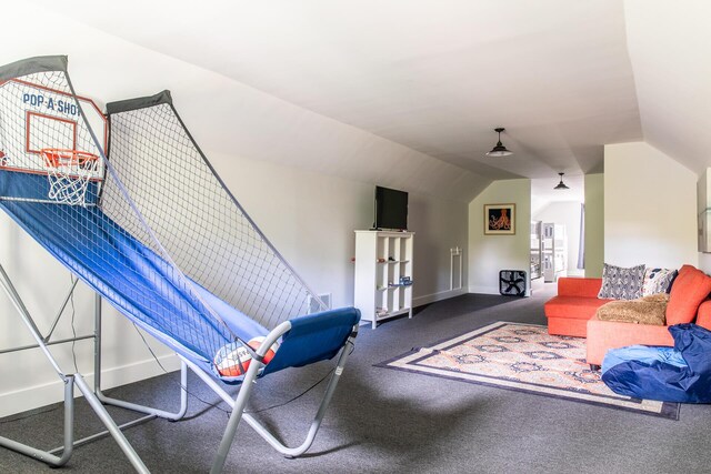 carpeted living area with baseboards and lofted ceiling
