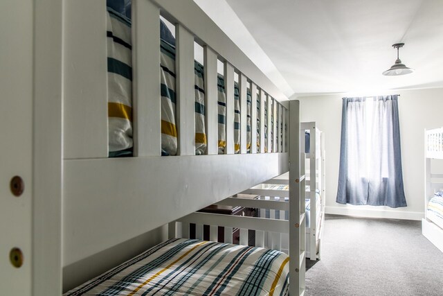 carpeted bedroom featuring baseboards