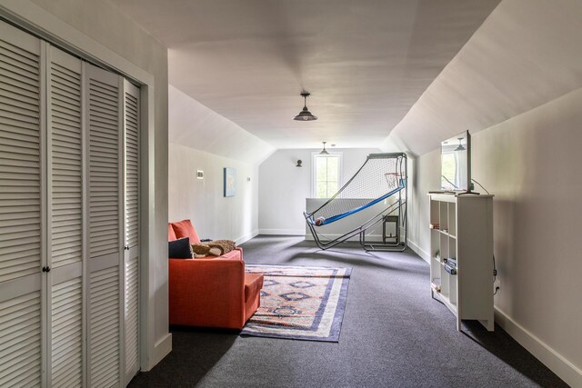 bedroom with carpet floors, baseboards, a closet, and lofted ceiling