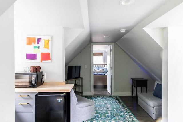 office area with recessed lighting, baseboards, dark wood finished floors, and vaulted ceiling