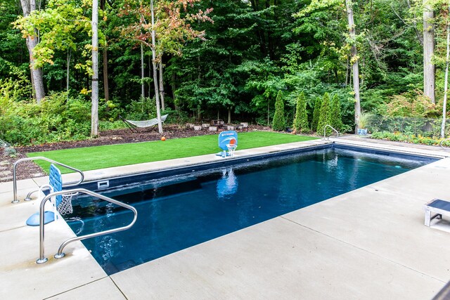 pool featuring a lawn and a patio