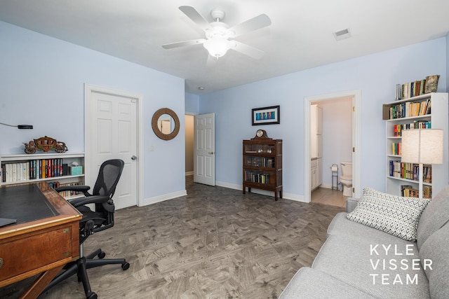 office with ceiling fan, visible vents, and baseboards