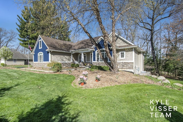 craftsman-style home featuring a front yard, a porch, and stone siding