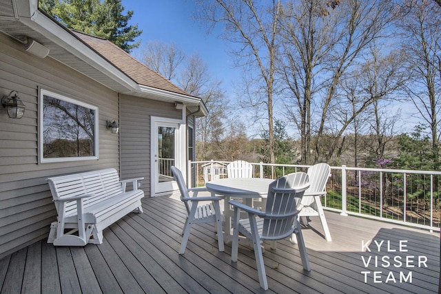wooden terrace with outdoor dining space