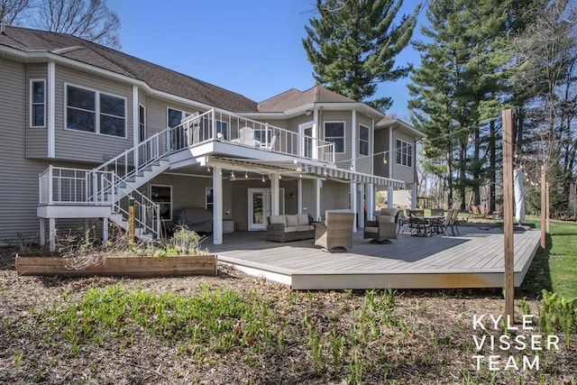 back of house with a wooden deck and outdoor lounge area
