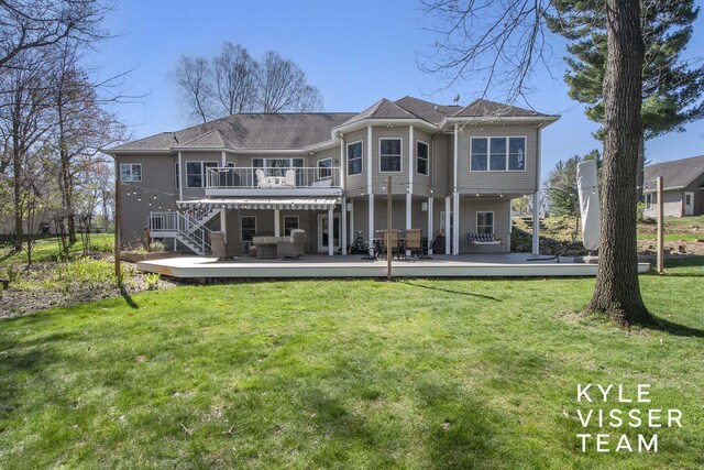 back of property featuring stairway, a yard, an outdoor living space, and a wooden deck