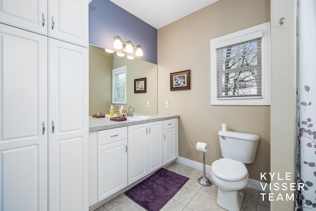 bathroom featuring baseboards, tile patterned flooring, vanity, and toilet