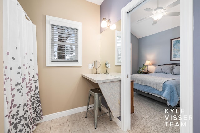 bedroom featuring baseboards, a ceiling fan, light tile patterned floors, and vaulted ceiling