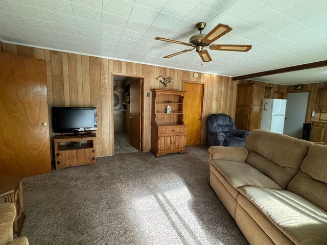 5940 Oak Rd, Rose City, MI 48654 - living room featuring wood walls, ceiling fan, and carpet floors