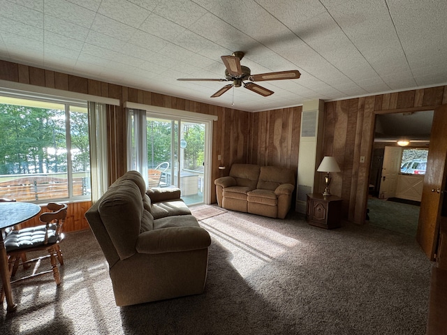 5940 Oak Rd, Rose City, MI 48654 - living room featuring carpet, wooden walls, and ceiling fan