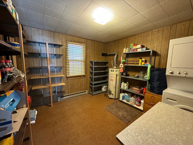 5940 Oak Rd, Rose City, MI 48654 - storage featuring a baseboard heating unit, water heater, and stacked washer / dryer