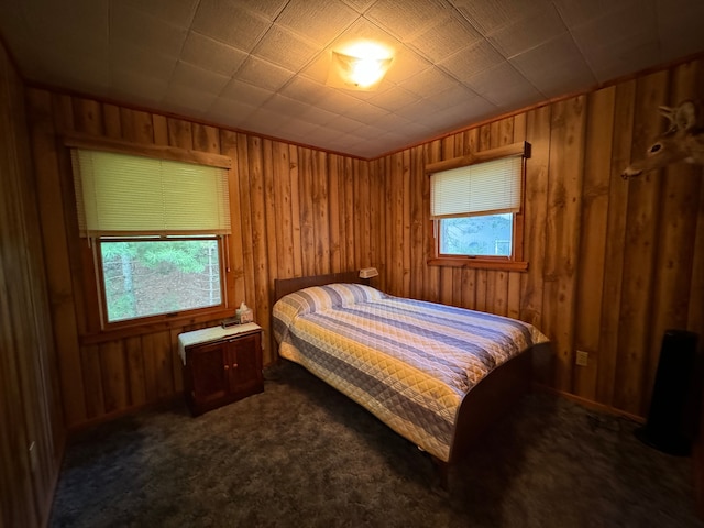 5940 Oak Rd, Rose City, MI 48654 - bedroom featuring wood walls, dark carpet, and multiple windows