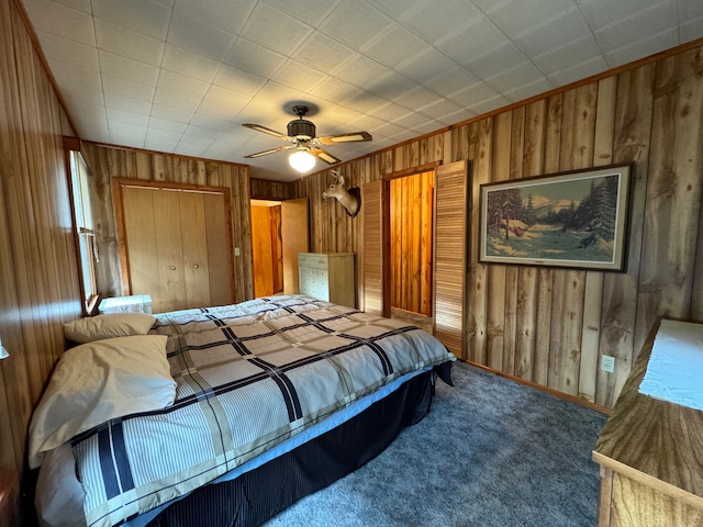5940 Oak Rd, Rose City, MI 48654 - carpeted bedroom featuring wooden walls, baseboards, and a ceiling fan