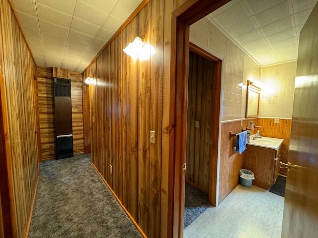 5940 Oak Rd, Rose City, MI 48654 - hall featuring tile patterned floors, wood walls, and a sink