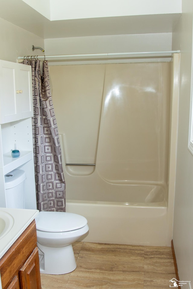 full bath with vanity, shower / bath combo, and toilet