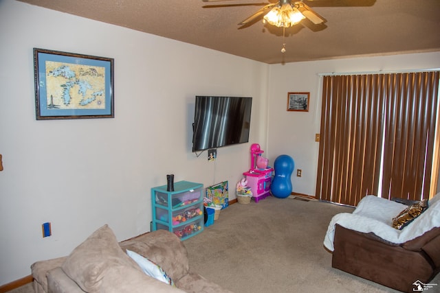 recreation room with baseboards, a ceiling fan, and carpet flooring