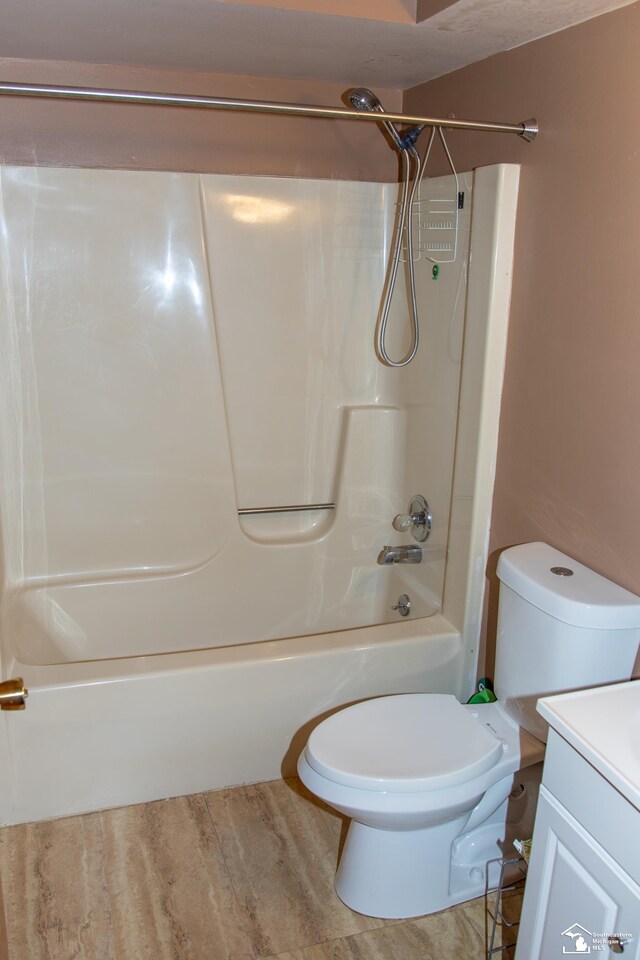 full bath with vanity, toilet, and shower / washtub combination