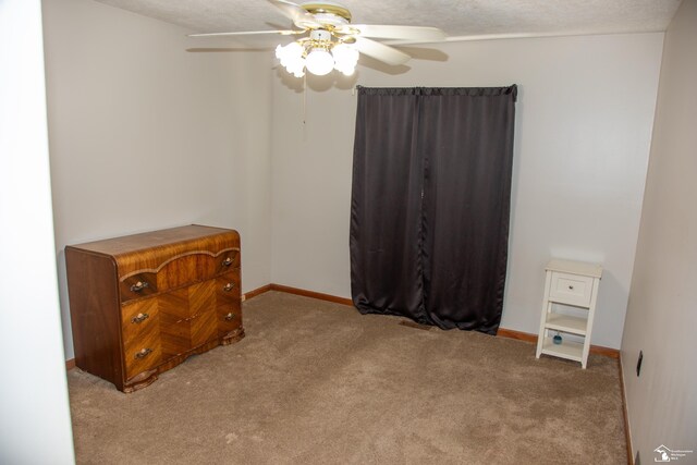 bedroom with baseboards, a textured ceiling, carpet, and ceiling fan