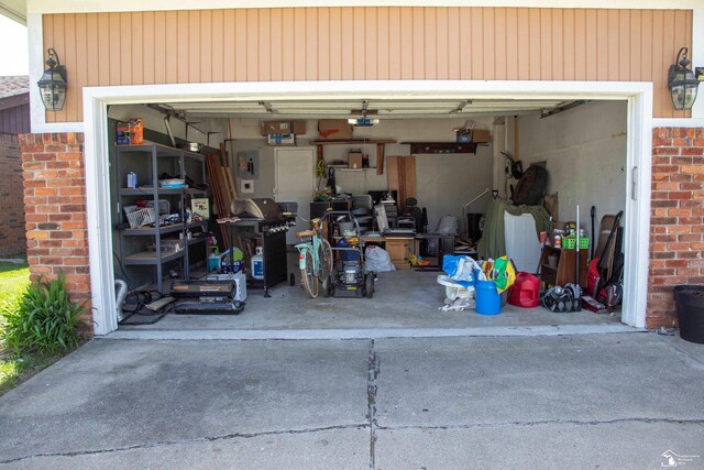 garage with a garage door opener and driveway