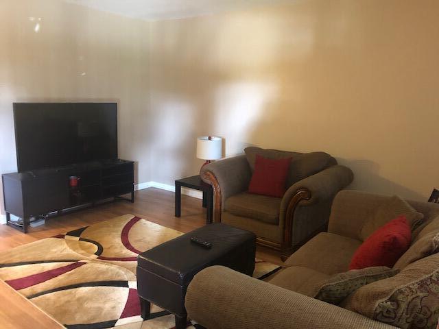 living area with baseboards and light wood-style flooring