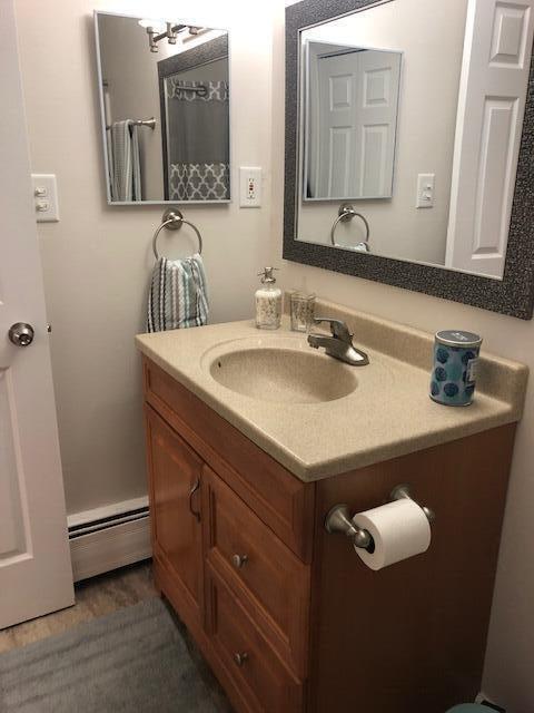 bathroom featuring a baseboard radiator and vanity