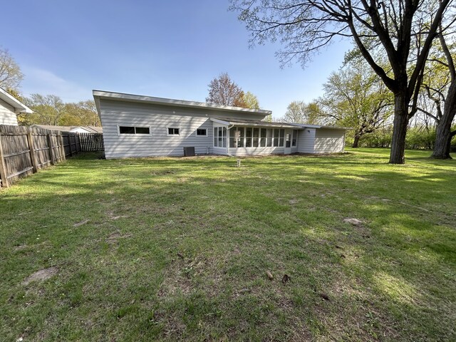 6735 Bayview Dr, Coloma, MI 49038 - rear view of house featuring fence, a sunroom, and a yard