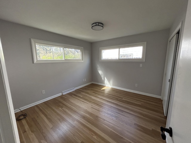 6735 Bayview Dr, Coloma, MI 49038 - unfurnished bedroom featuring baseboards, wood finished floors, visible vents, and a closet