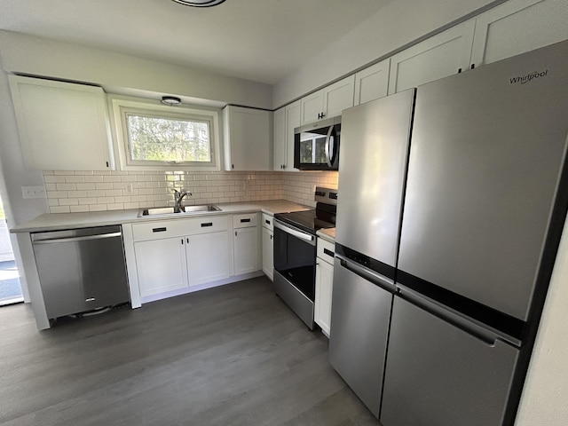 6735 Bayview Dr, Coloma, MI 49038 - kitchen with backsplash, white cabinetry, appliances with stainless steel finishes, and dark wood-style floors