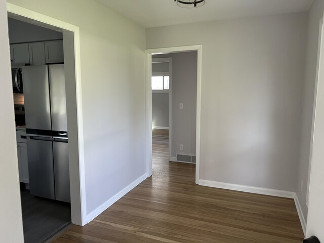 6735 Bayview Dr, Coloma, MI 49038 - corridor featuring baseboards, visible vents, and dark wood-style floors