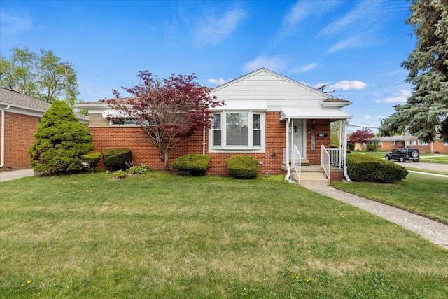 view of front of property featuring a front lawn and brick siding