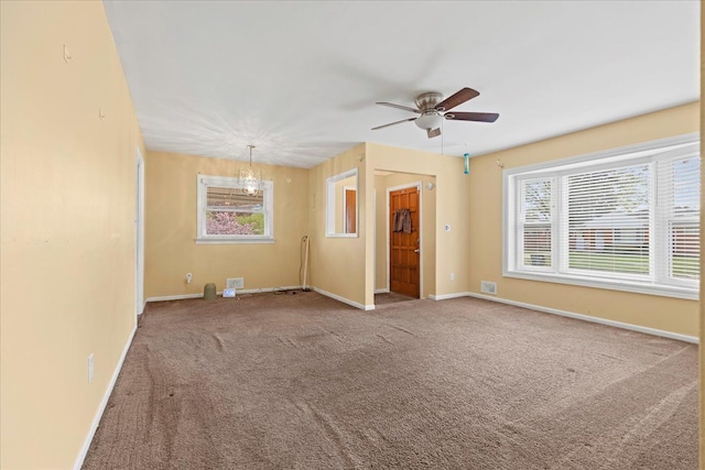 carpeted spare room with baseboards and ceiling fan