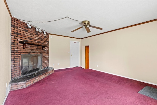 unfurnished living room featuring crown molding, ceiling fan, carpet floors, a brick fireplace, and baseboards