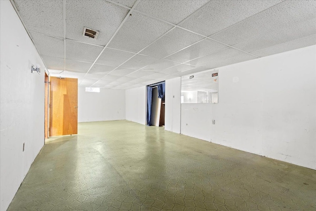 basement with a paneled ceiling