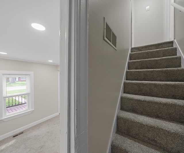 stairs with visible vents, carpet flooring, baseboards, and recessed lighting