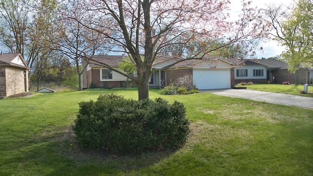 single story home featuring an attached garage, driveway, a front lawn, and brick siding